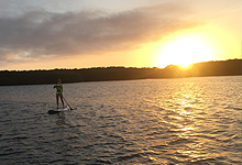 paddle boarding at sunset